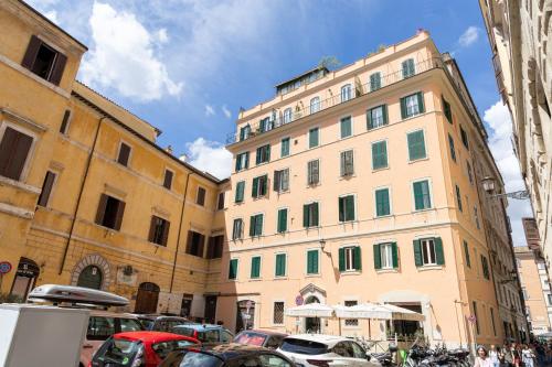 a group of buildings and cars parked in a parking lot at MH Luxury Suite Pantheon in Rome