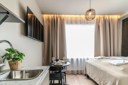 a bedroom with a bed and a sink and a table at Frost Apartments by Heimaleiga in Reykjavík