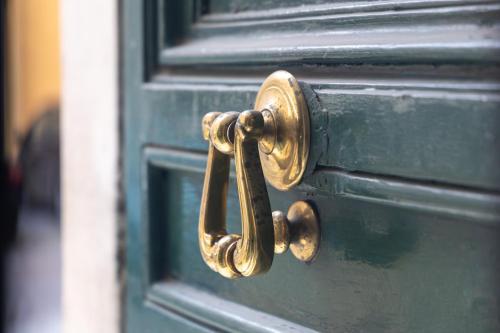 a bronze door handle on a green door at MH Luxury Suite Pantheon in Rome