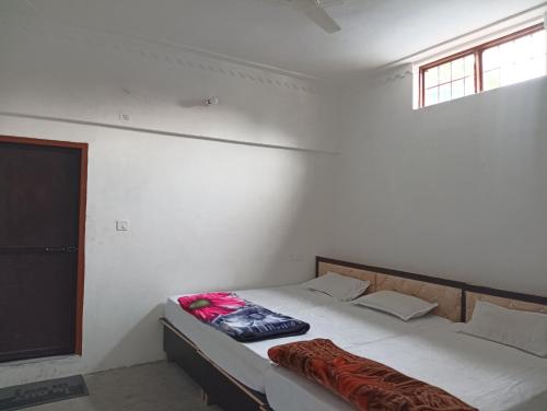 a bedroom with a bed with a pillow on it at Vasudhara Hotel & Restaurant in Pīpalkoti