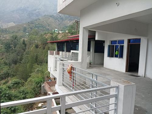 a balcony of a house with a view of a mountain at Vasudhara Hotel & Restaurant in Pīpalkoti