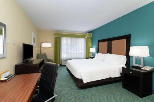 a large hotel room with a bed and a desk at Hilton Garden Inn Dalton in Dalton