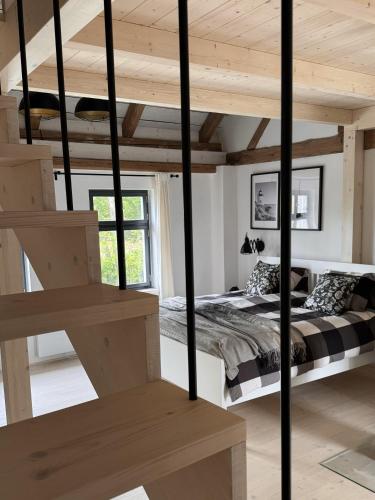 a bedroom with a bed in a room with wooden ceilings at Semtěš 5 in Pšov