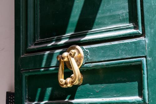 a green door with a gold door knocker on it at MH Luxury Suite Pantheon in Rome
