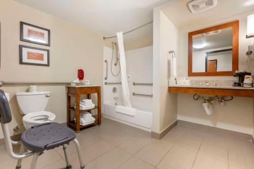 a bathroom with a shower and a toilet and a sink at Comfort Suites Redding - Shasta Lake in Redding
