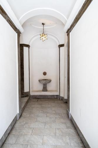 an empty hallway with a ceiling fan and a table at MH Luxury Suite Pantheon in Rome