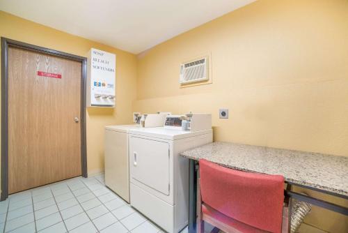 a kitchen with a counter and a washer and dryer at Quality Inn O'Fallon IL - St Louis in O'Fallon