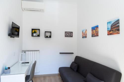 a living room with a couch and pictures on the wall at MH Luxury Suite Pantheon in Rome