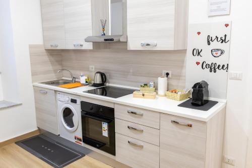 a kitchen with a sink and a washing machine at MH Luxury Suite Pantheon in Rome