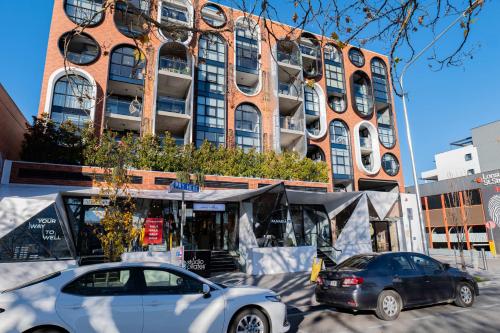 two cars parked in front of a building at 2 Bedroom 2 bath 1 Car on Lonsdale Street in Canberra