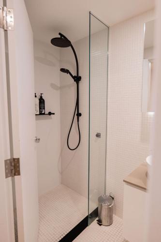 a shower with a glass door in a bathroom at 2 Bedroom 2 bath 1 Car on Lonsdale Street in Canberra