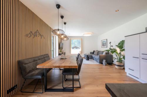 a dining room with a wooden table and chairs at Apartment Mountainview in Neustift im Stubaital