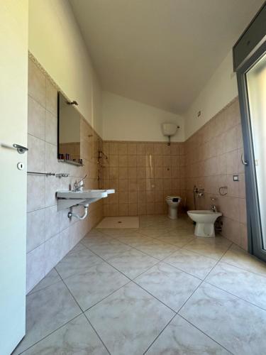 a bathroom with a sink and a toilet at Sole&Luna in Armungia