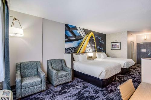 a hotel room with two beds and two chairs at Clarion Pointe Franklin - Nashville Area in Franklin