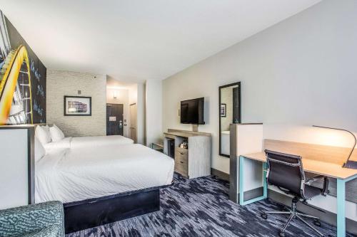 a hotel room with a bed and a desk at Clarion Pointe Franklin - Nashville Area in Franklin