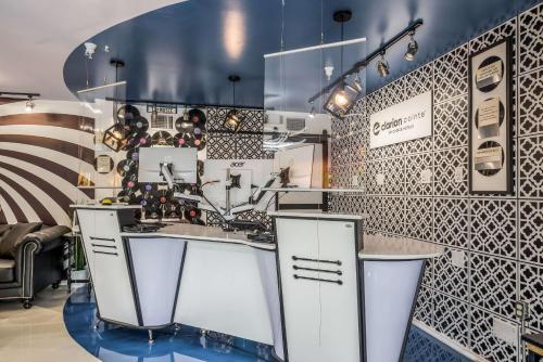 a kitchen with black and white patterned walls at Clarion Pointe Tallahassee-State Capitol in Tallahassee