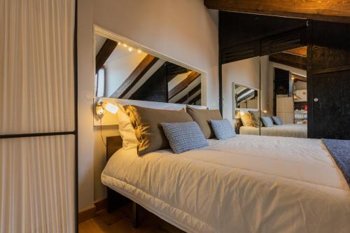 a bedroom with a large bed with a large mirror at Barbaroux Apartments by Wonderful Italy in Turin
