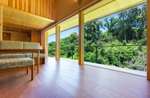 a living room with large windows and a couch at 清閑寺池田倶楽部 in Kyoto