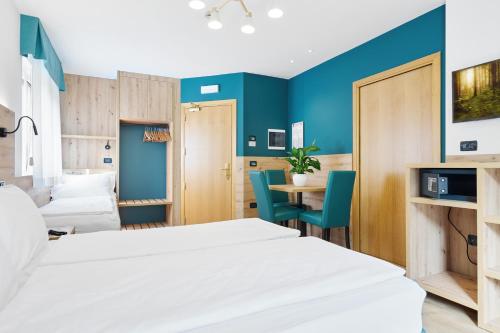 a hotel room with a bed and a table at Residence Hotel Miralago in Pergine Valsugana