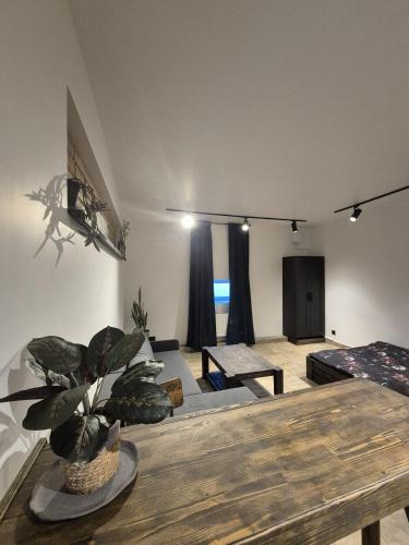 a living room with a table and a couch at Zvaigžņu Apartment in Ogre