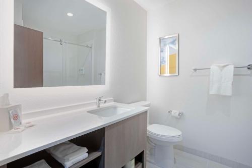 a white bathroom with a sink and a toilet at Comfort Inn & Suites US-60 in Mountain Grove