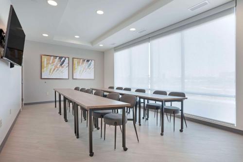 a conference room with tables and chairs and a large window at Comfort Inn & Suites US-60 in Mountain Grove