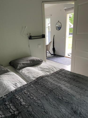 a bedroom with a bed and a door to a patio at VillaAttefall in Färjestaden