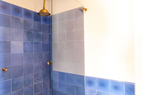 a blue tiled shower with a blue tile wall at Faranda Collection Barranquilla, a member of Radisson Individuals in Barranquilla