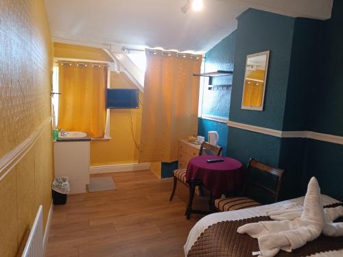 a room with a bed and a table in a room at Jewel Of The Sea Hotel in Blackpool