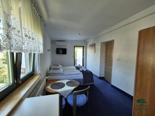 a room with a bed and a table in it at Apartamenty Maria in Ciechocinek