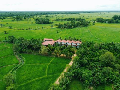 an aerial view of a house in a green field at Rivonway Hotel Polonnaruwa in Polonnaruwa