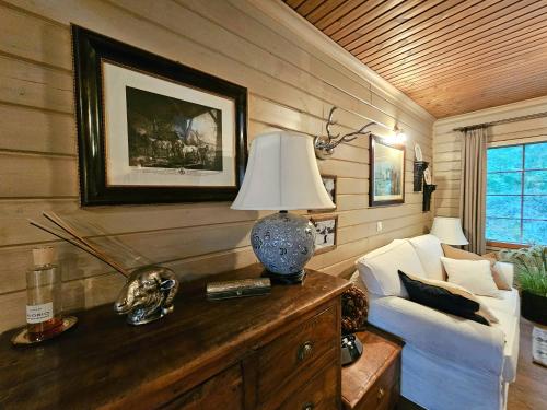 a living room with a couch and a lamp on a table at Kerimaa Golf Chalet close to Savonlinna in Savonlinna