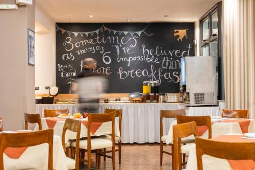 a restaurant with a chalkboard on the wall at Hotel Marina in Athens