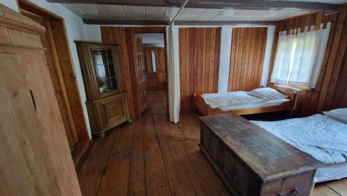 a bedroom with two beds and a wooden floor at Dom Przysłupowy Educare -Agroturystyka Slow Food in Świeradów-Zdrój