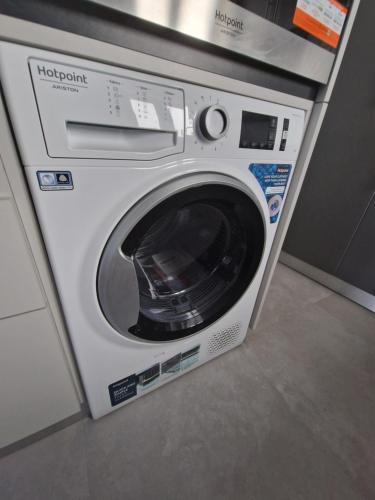 a white washing machine sitting in a room at TuKaza by Geyra - Fão in Esposende