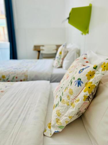 two beds with pillows on them in a bedroom at Central and Basic Universitat for YOUNG HOSTEL in Barcelona