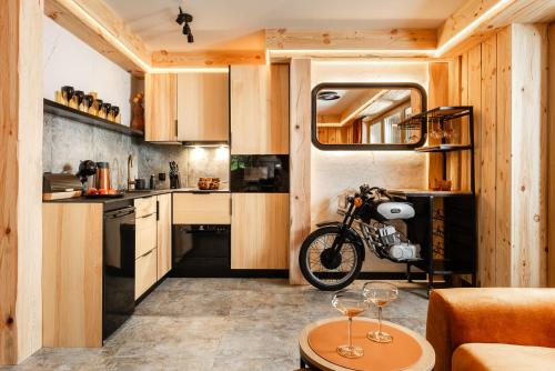a bicycle is parked in a kitchen in a tiny house at Brzozowa Osada - Premium Chalets Zakopane in Zakopane