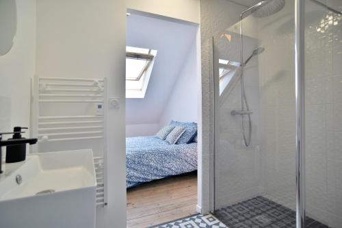 a bathroom with a shower and a sink and a bed at La Villa des Fontenelles - Proche de la mer in Carolles