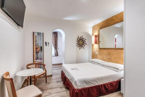 a hotel room with a bed and a mirror at Hotel Santa Prassede in Rome