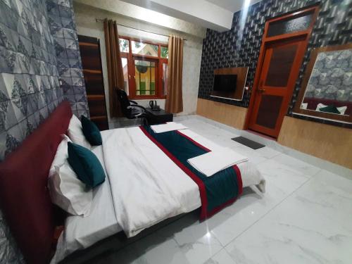 a bedroom with a bed and a television in it at Hotel O Graceland in Srīnagar