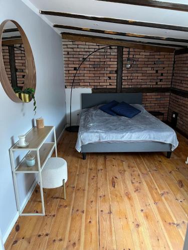 a bedroom with a bed and a wooden floor at Apartamenty Kowary Centrum in Kowary
