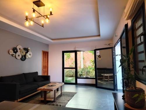 a living room with a couch and a table at Flora Hotel Ivato International Airport in Antananarivo