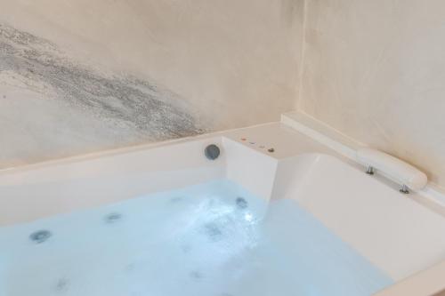 a bathroom with a bathtub with water on the wall at Hotel Santa Prassede in Rome