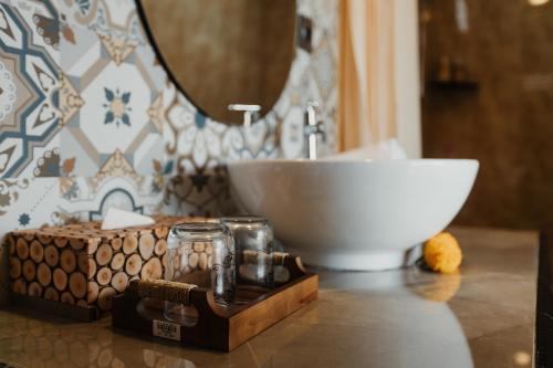 a bathroom counter with a sink and a bowl at Dana's House in Tabanan