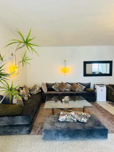 a living room with a couch and a glass table at Appartement spacieux - BD Anfa in Casablanca