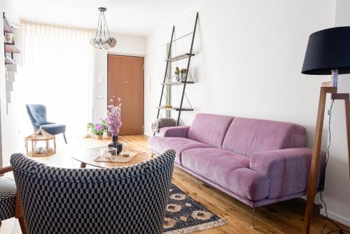 a living room with a purple couch and a table at Il Pino - Montefiascone in Montefiascone