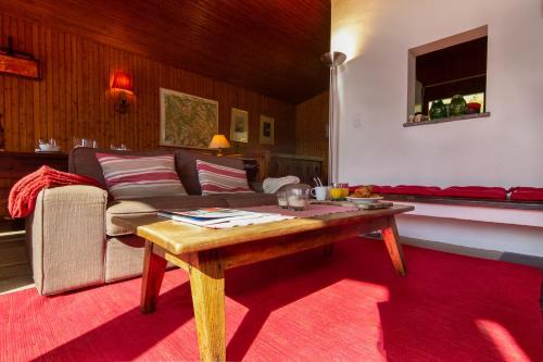 a living room with a couch and a coffee table at Chalet Dava La Via ski in - ski out - Happy Rentals in Chamonix-Mont-Blanc