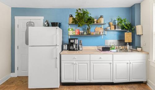 a kitchen with a white refrigerator and a sink at East end. Walk to food, beer and downtown fun. in Portland