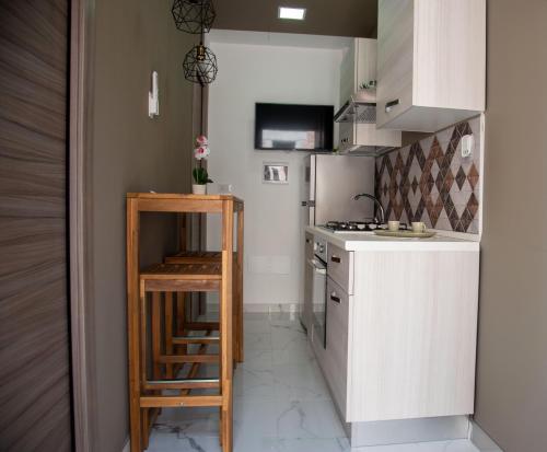 a small kitchen with a stove and a refrigerator at Casa Vacanze - Bovalino in Bovalino Marina