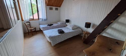 Posteľ alebo postele v izbe v ubytovaní Gite Aux Anciennes Ecuries
